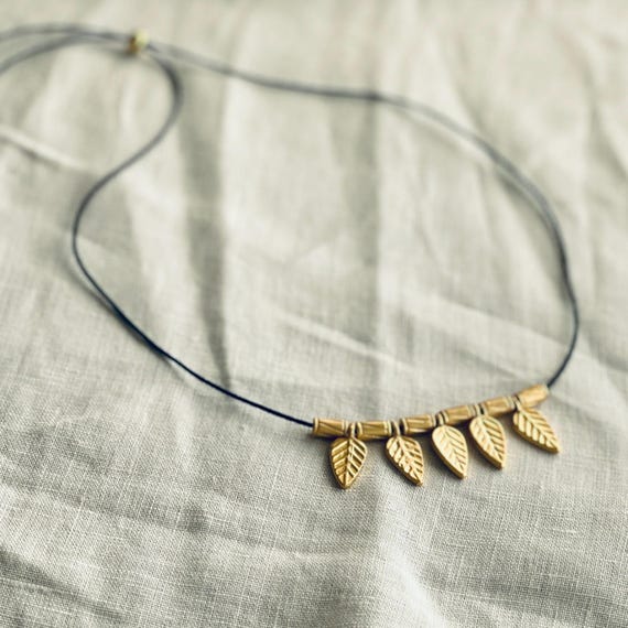 Cord necklace with gold leaf charms