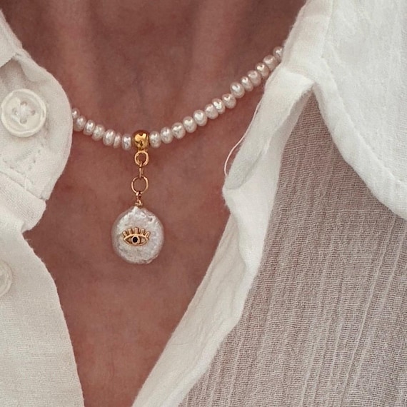 Pearl necklace with reversible evil eye drop charm pendant