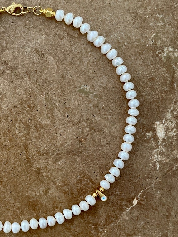 Boho style pearl necklace with mini evil eye charm