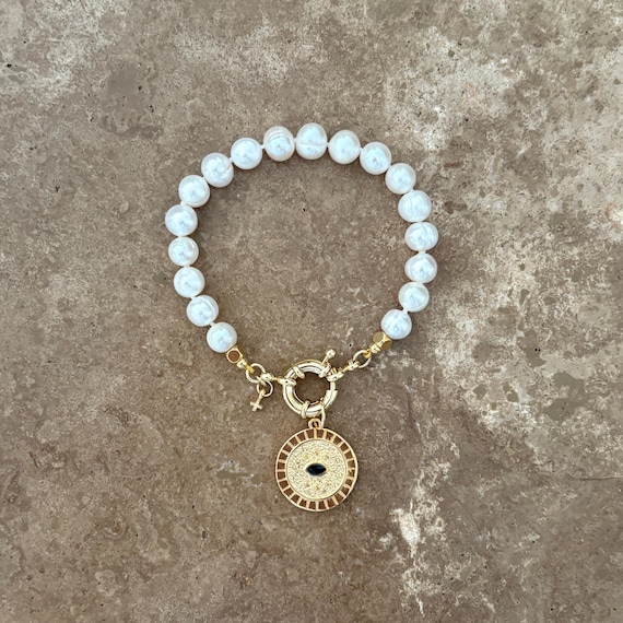 Convertible pearl charm bracelet with detachable evil eye and mini gold cross