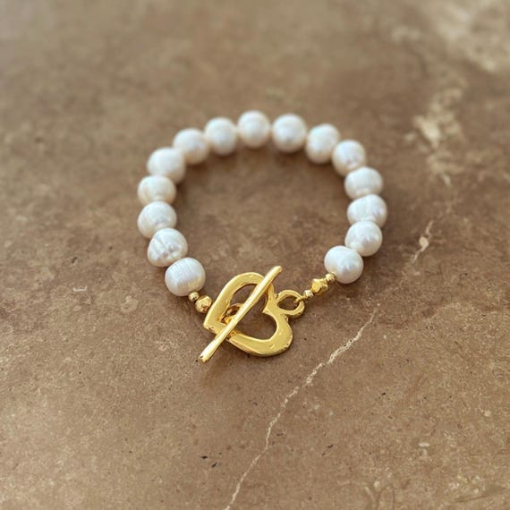 Statement pearl bracelet with chunky gold heart clasp