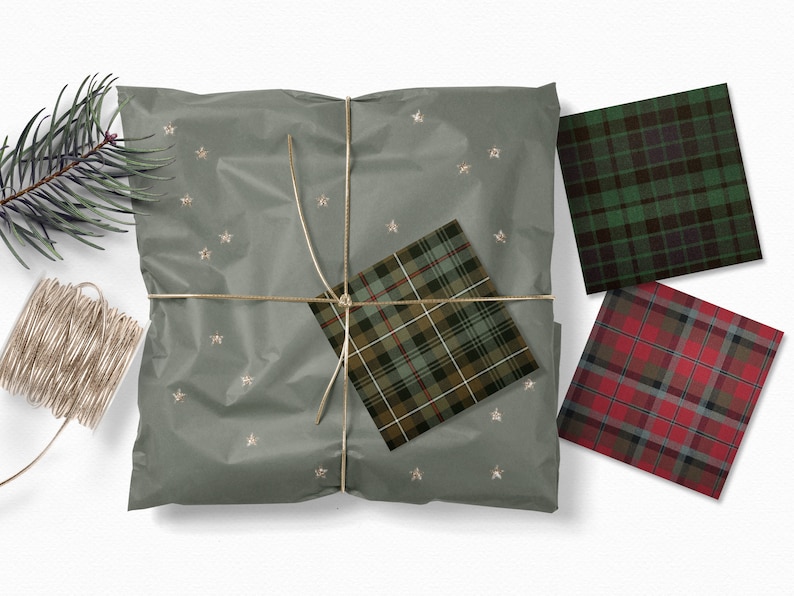 May include: A green, brown, and white plaid wrapping paper with gold stars on a gray background. The paper is tied with twine and there are three additional squares of plaid wrapping paper in green, red, and black.