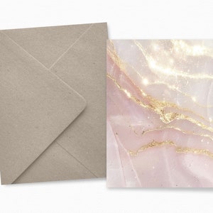 May include: A stationery set featuring a light pink and gold marble design. The card has a shimmering effect with gold veins. A matching light brown envelope is included, creating an elegant and cohesive look. Ideal for invitations or special notes.
