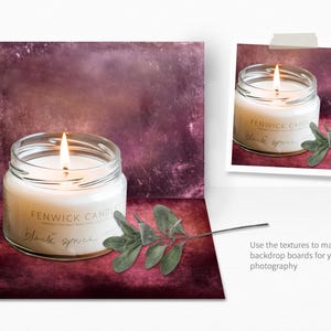 May include: A glass jar candle with a white wax and a lit wick. The jar has a label that reads "Fenwick Candles" and "Black Spruce". The candle is sitting on a textured, burgundy background with a sprig of green foliage.