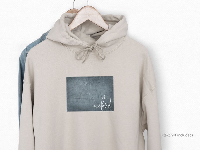 May include: A beige hoodie with a blue and gray textured rectangle graphic and the word "iceland" written in white script.
