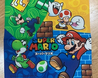 May include: A blue, yellow, green, and red Super Mario Bros. themed bandana featuring images of Mario, Luigi, Yoshi, and a Goomba. The bandana has the text "SUPER MARIO" and "スーパーマリオ" in Japanese.