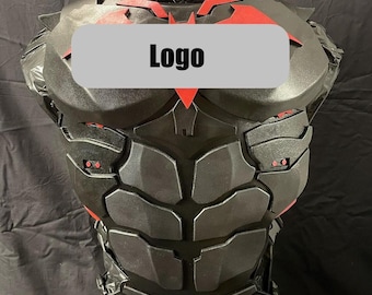 May include: A black chest armor piece featuring a segmented abdominal design and a red bat-shaped emblem on the upper chest. The armor includes a gray rectangular overlay with the text Logo printed in black across the center of the chest area.
