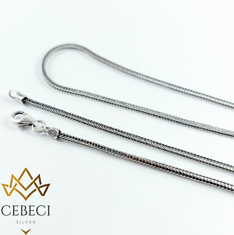 May include: A silver chain necklace with a 925 stamp. The chain is a snake chain style.