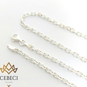 May include: Three silver chains with a lobster clasp. The chains are made of a delicate, oval-shaped link.