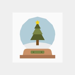 May include: A snow globe with a green Christmas tree inside. The tree has a yellow star on top and is sitting on a white base. The snow globe is on a brown wooden base.