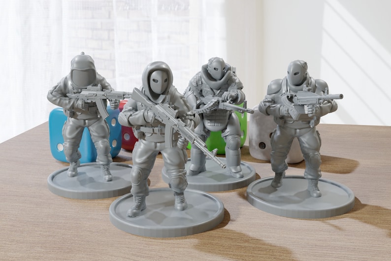 May include: Four gray plastic figurines of soldiers wearing helmets and holding guns. The soldiers are standing on round bases.