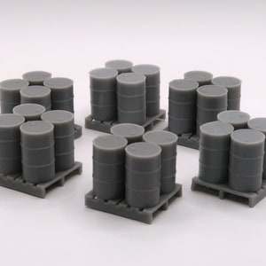 May include: A set of gray plastic model barrels stacked on pallets. The barrels are arranged in three groups of six, with each group on a separate pallet.