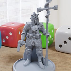 May include: A gray figurine of a warrior in armor, holding a pistol and a staff with a cross. The figurine stands on a round base. Colorful dice in blue, red, green, and white are in the background.