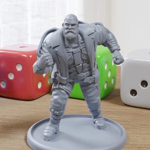 May include: A gray painted miniature figurine of a man wearing a leather jacket and a beard. The figurine is standing on a gray base. The figurine is surrounded by four dice.