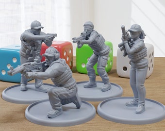 May include: Four gray plastic figurines of people wearing tactical gear and holding guns. The figurines are standing on gray circular bases. The figurines are on a wooden surface with three colorful dice.