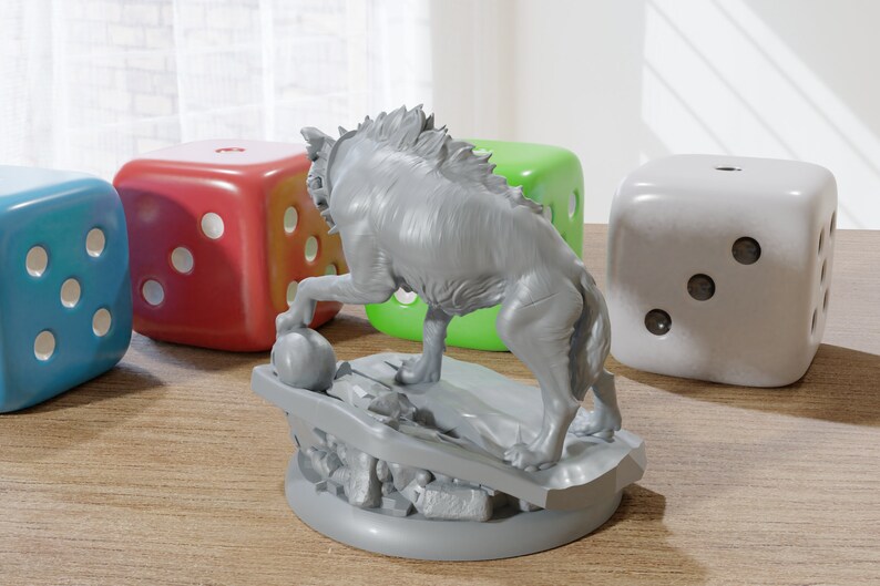 May include: A gray, detailed miniature of a wolf-like creature standing on a rocky base. The miniature is painted in a light gray color and has a textured surface. The creature is holding a small, round object in its paw.