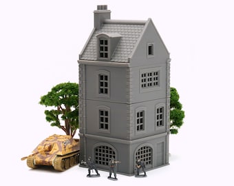 May include: A gray three-story building with a chimney and a roof made of gray shingles. The building has windows on each floor and a garage door on the bottom floor. There are four small figures standing in front of the building.