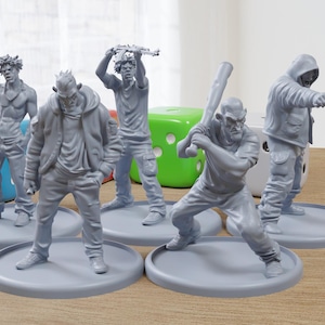 May include: A collection of gray miniature figures depicting various characters in action poses. One figure holds a baseball bat, another a gun, and others are in dynamic stances. The figures are on gray circular bases.