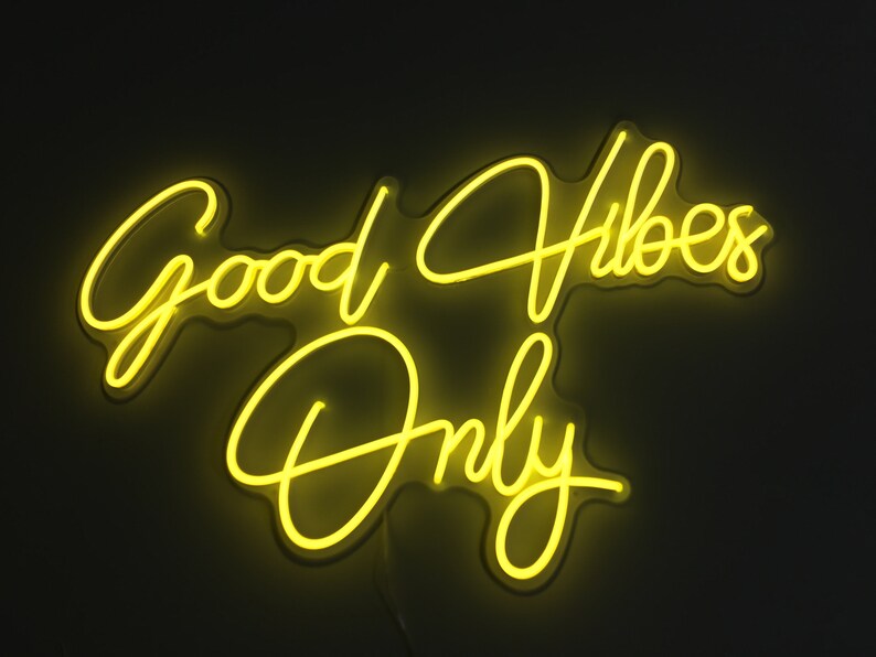 May include: Yellow neon sign with the text "Good Vibes Only" in a cursive font.