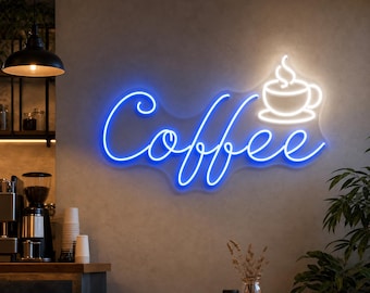 Puede incluir: Un letrero de neón con la palabra "Coffee" en escritura azul, acompañado de un icono de taza de café blanco. El letrero está montado en una pared gris, con un ambiente de cafetería en el fondo.