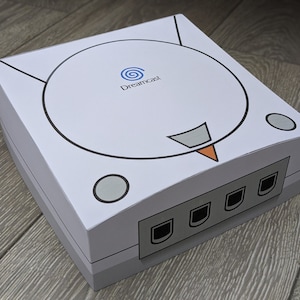 Housse anti-poussière et protecteur de lumière Papercraft pour Sega Dreamcast (version PAL avec logo bleu)