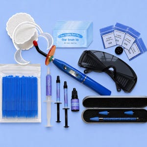 May include: A teeth whitening kit featuring a blue LED curing light, protective black glasses, a cheek retractor, three syringes of whitening gel, a small bottle of liquid, blue micro-brushes, dental wipes, clear crystal rhinestones, and a gem applicator tool.