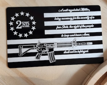 May include: A black and silver metal card with a stylized image of a rifle and the text "A well regulated Militia, being necessary for the security of a free State, the right of the people to keep and bear Arms, shall not be infringed." The card also features a circle of stars with the text "2ND" in the center.