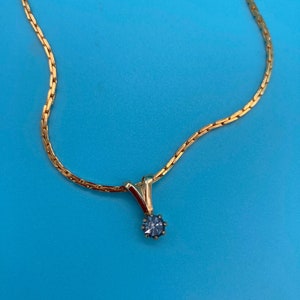 Gold-tone necklace with rhinestone pendant