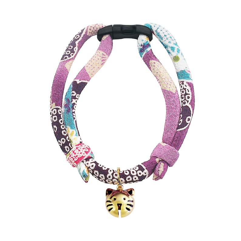 May include: A purple and pink patterned cat collar with a gold cat-shaped bell charm.