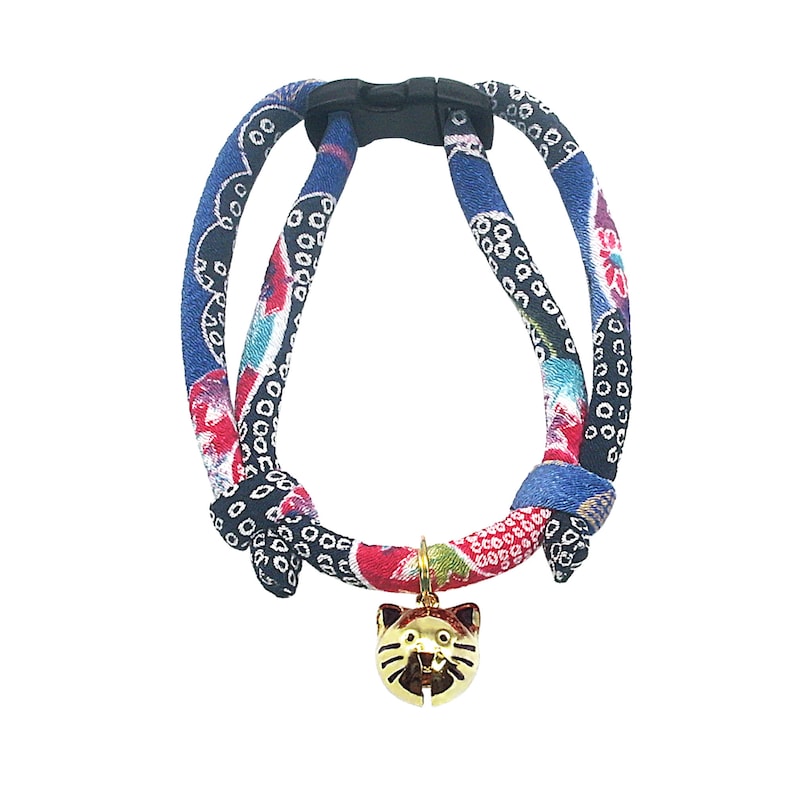 May include: A blue, red, and black patterned cat harness with a gold cat-shaped bell.