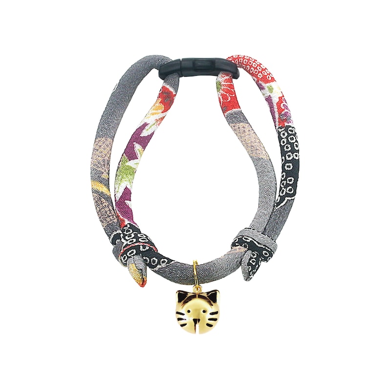 May include: A gray, red, and purple cat collar with a gold cat charm. The collar is made of fabric and has a plastic buckle.