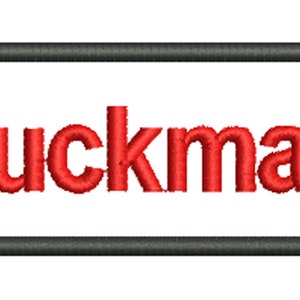 May include: A white rectangular patch with a black border and the word "Buckman" embroidered in red.