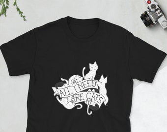 May include: Black t-shirt with a white graphic of cats and a banner that reads "All I need are cats."