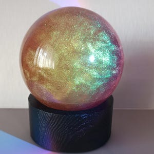 Magic Snow Globe Pearl chameleon. Glass globe. from Ukraine. Black wood base.