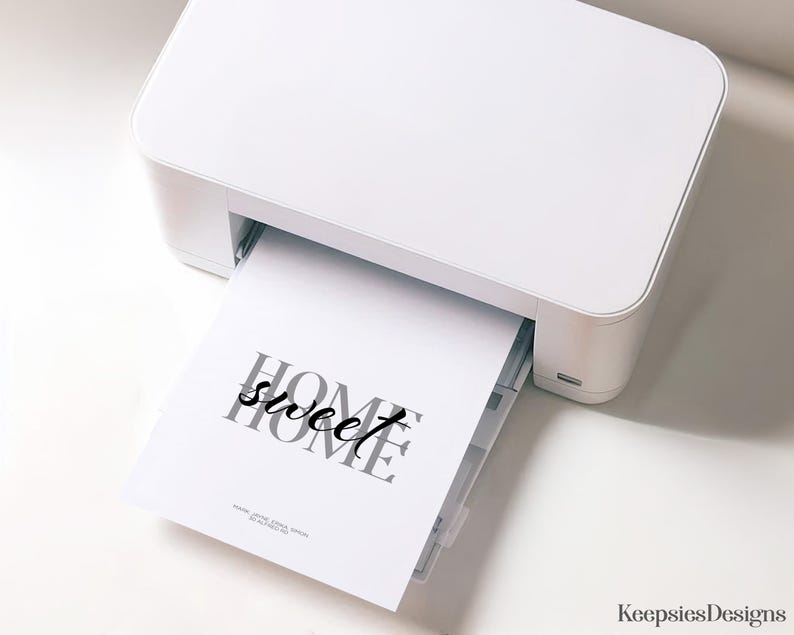 A white home printer printing out a home sweet home art print sheet.
