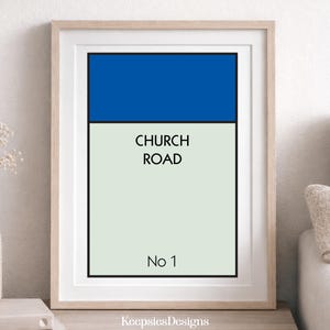 May include: A framed vertical wall art print featuring a blue rectangular block at the top over a light cream background. The text CHURCH ROAD is printed in black in the centre, with No 1 printed in black at the bottom, all inside a light wood frame.