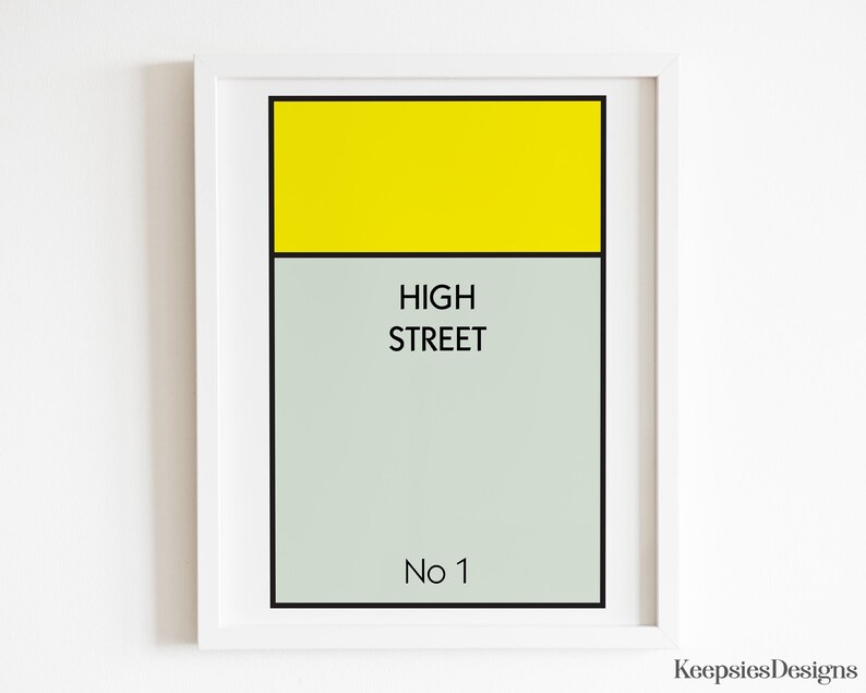 May include: A framed wall art print featuring a rectangular graphic design with a bright yellow top section and a light grey bottom section. The text HIGH STREET is printed in black in the centre, with No 1 printed in black at the bottom.