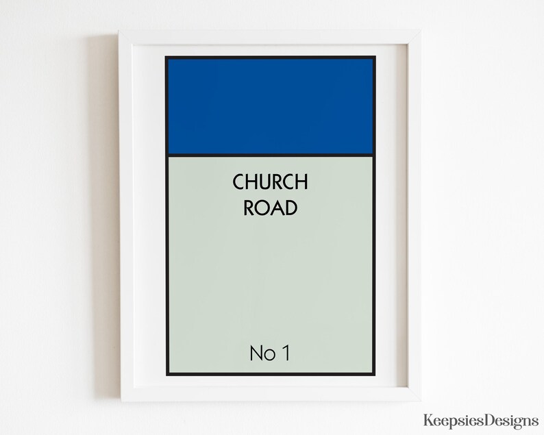 May include: A framed wall art print featuring a rectangular design with a solid blue top section and a light grey bottom section. The text CHURCH ROAD is printed in black in the centre, with No 1 printed in black at the bottom of the print.