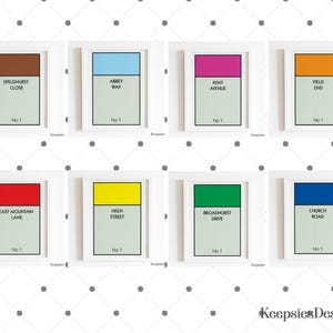 May include: Eight framed rectangular prints arranged in two rows, each featuring a coloured header bar, a street name, and the text No 1. The street names include Speldhurst Close, Abbey Way, Kent Avenue, Field End, East Mountain Lane, High Street, Broadhurst Drive, and Church Road. The brand name Keepsies Designs appears in the bottom right corner.