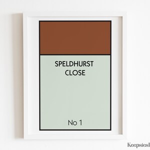 May include: A framed rectangular wall art print featuring a brown horizontal block at the top and a light sage green block below. The text SPELDHURST CLOSE is printed in black in the centre, with No 1 printed in black at the bottom of the print.