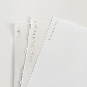 May include: Close-up of two white paper samples. The sample on the left has a deckle edge and is labelled "Deckle". The sample on the right has a smooth edge and is labelled "Cardstock". The sample in the middle has a deckle edge and is labelled "Deckle Hand Ripped".