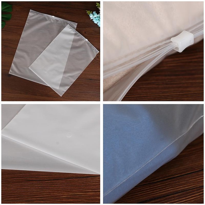 May include: Two clear plastic zippered storage bags, one slightly larger than the other, are laid out on a wooden surface. The bags are made of a thin, translucent material and have a zipper closure along the top edge. The zipper is white and has a small plastic slider.