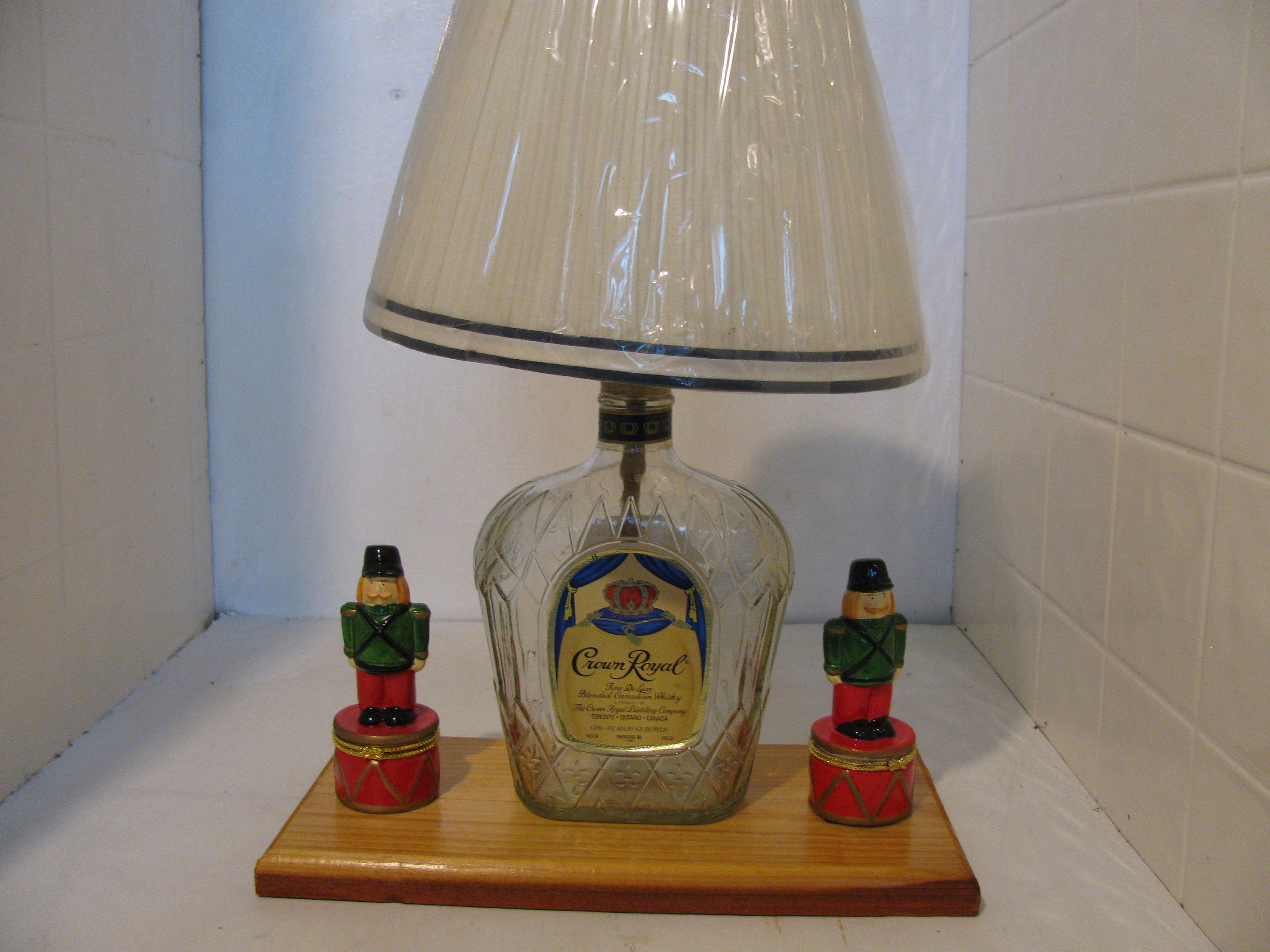 Home Made Crown Royal decanter made into a lamp w/ 2 drummer boys,resting on a cypress plaque