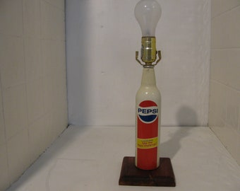 Home Made Aluminum pepsi bottle made in to a real pretty lamp.Its also red white & blue.For any occasion.