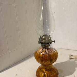 Old oil lamp Filled with seashells Really neat