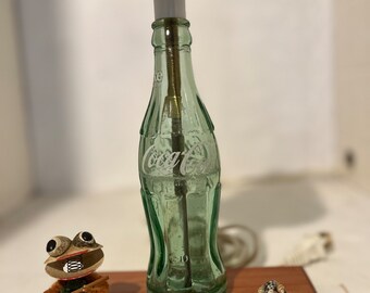 Home made nite lite out of a recycled old 6 1/2 oz coke bottle. It has a couple of home made sea shell characters with it.