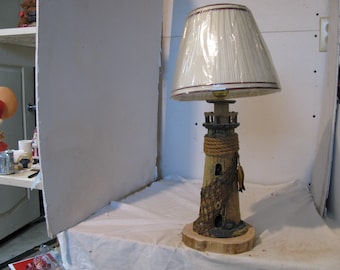 Old light house w/ fish net wrapped around,made into a lamp