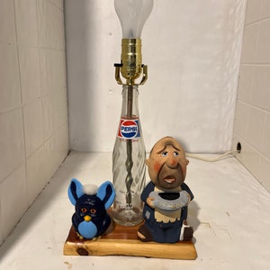 Homemade Lamp from a old 10 oz Pepsi bottle, with a cedar base. Has a couple of characters with it.Rufes & doofus.