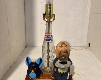 Homemade Lamp from a old 10 oz Pepsi bottle, with a cedar base. Has a couple of characters with it.Rufes & doofus.