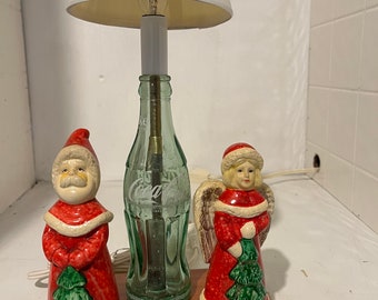 Christmas nite lite, made from a recycled 6 1/2 oz coke bottle. With a santa & an angel. Very nice